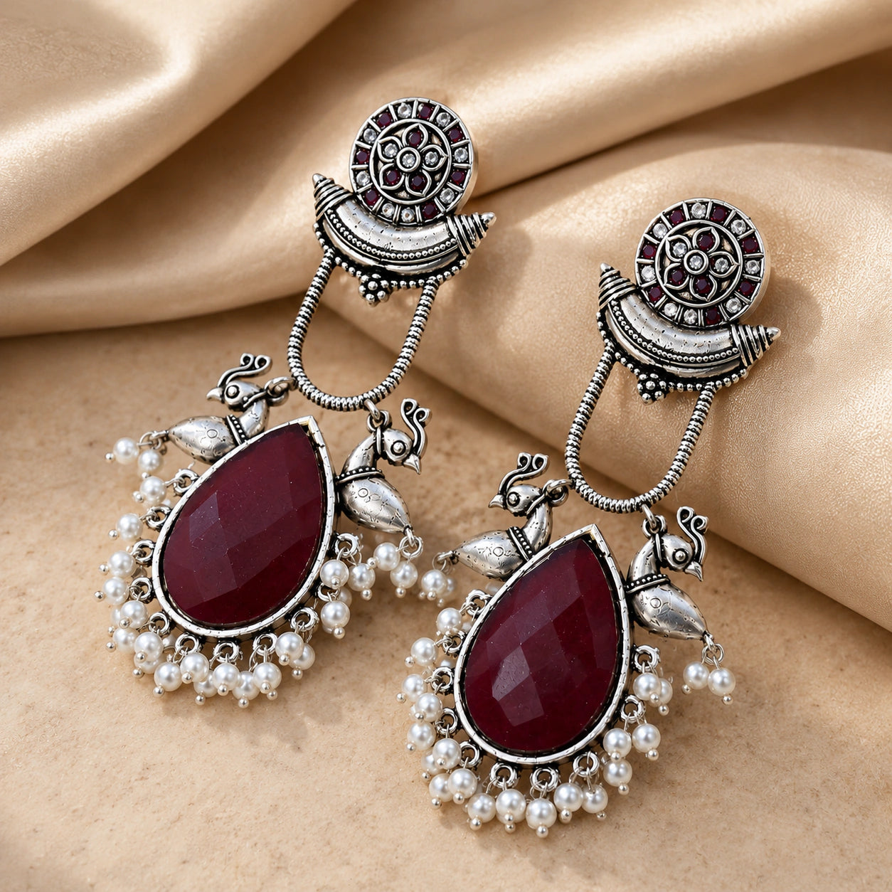 Alternate product view of German silver maroon pearl bird-motif earrings