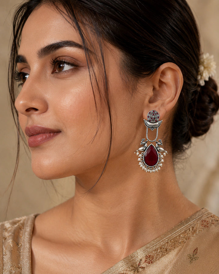 German silver maroon pearl bird-motif dangle earrings worn by a model