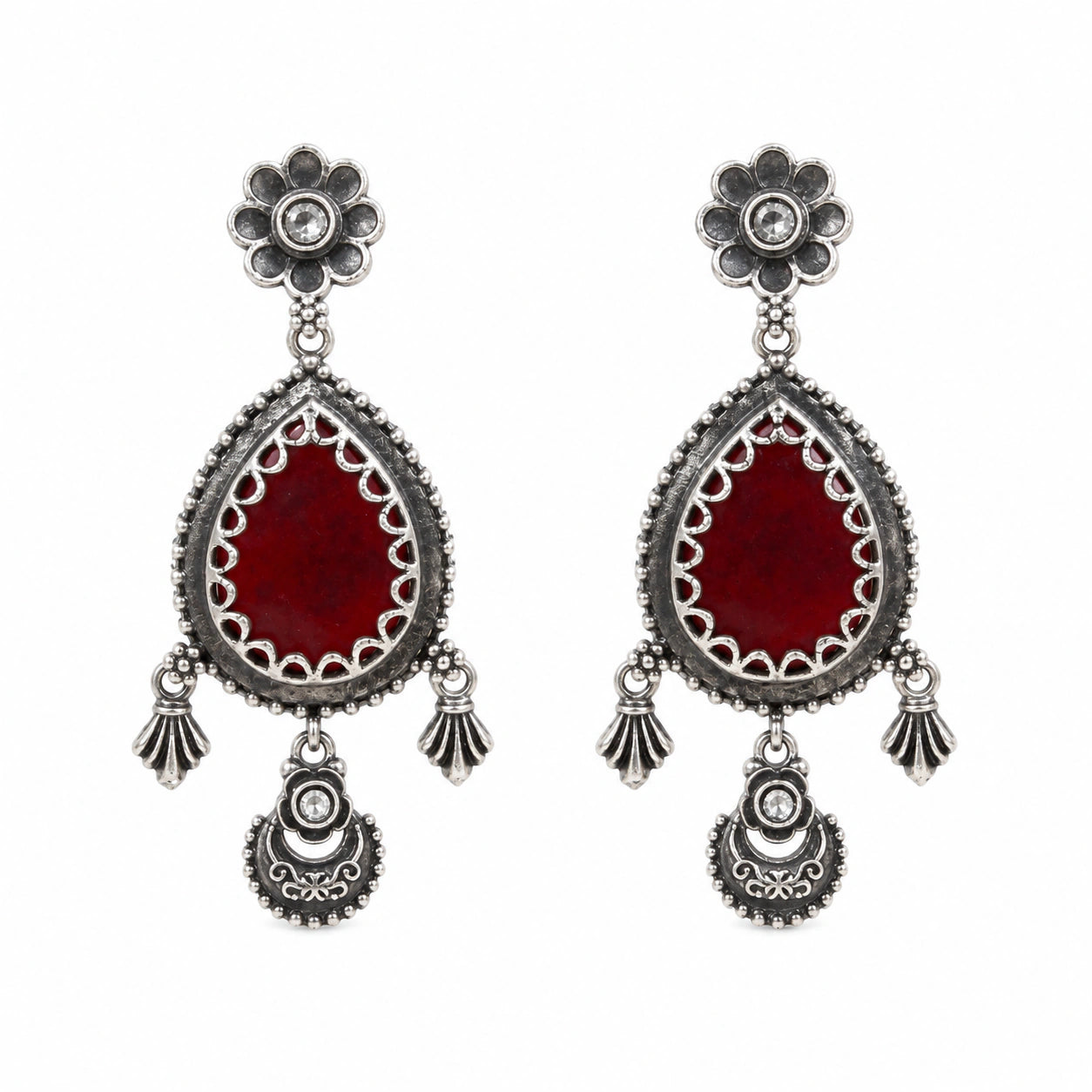 Maroon teardrop floral dangle earrings on a dark jewellery studio display