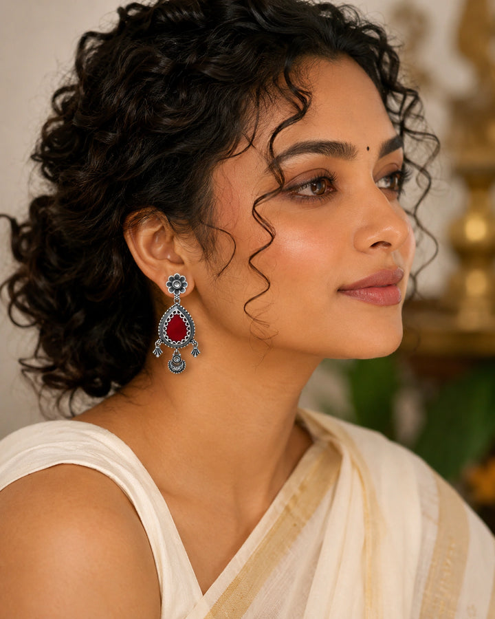German silver maroon teardrop floral dangle earrings worn by a model