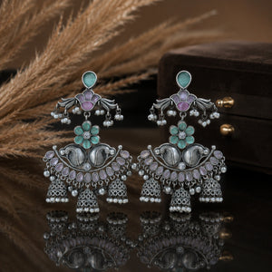 Mint purple pearl chandelier earrings on a dark jewellery studio display