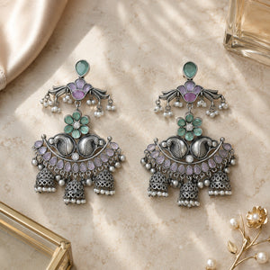 Mint purple pearl chandelier earrings styled in an elegant jewellery flat lay