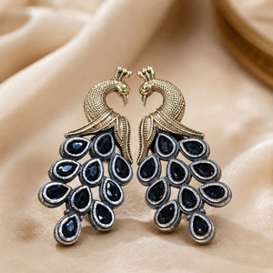 German silver navy peacock chandelier earrings styled in a jewellery flat lay