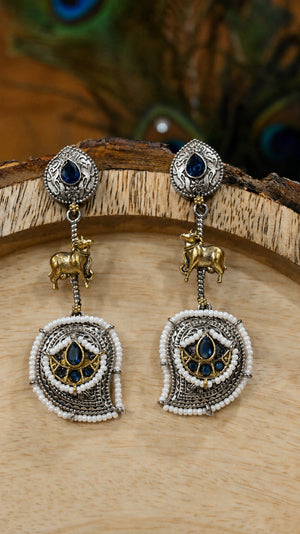 Close-up ear view showing navy accents, cow motifs and pearl layers