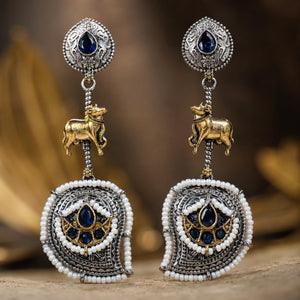 Close-up of navy blue accents, cow motifs and pearl chandelier detailing