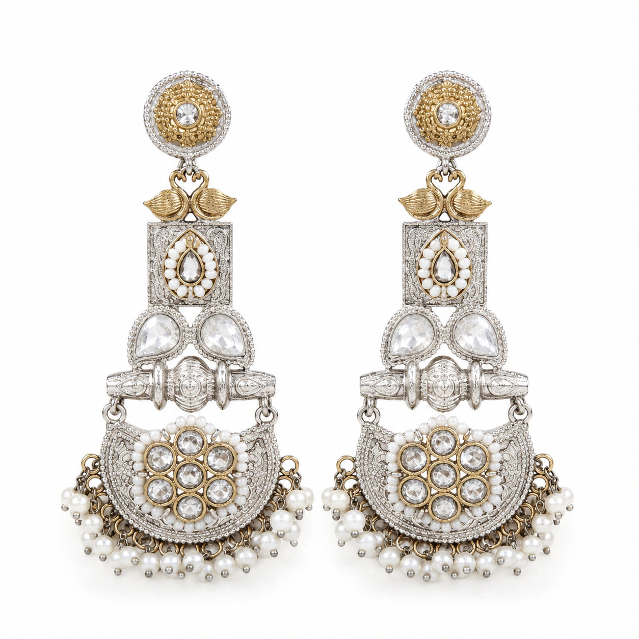 Pearl-style crystal chandelier earrings on a dark jewellery studio display