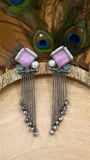 Close-up ear view showing pink accents and pearl-style hanging details