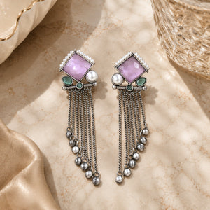 German silver pink pearl-style dangle earrings styled in a jewellery flat lay