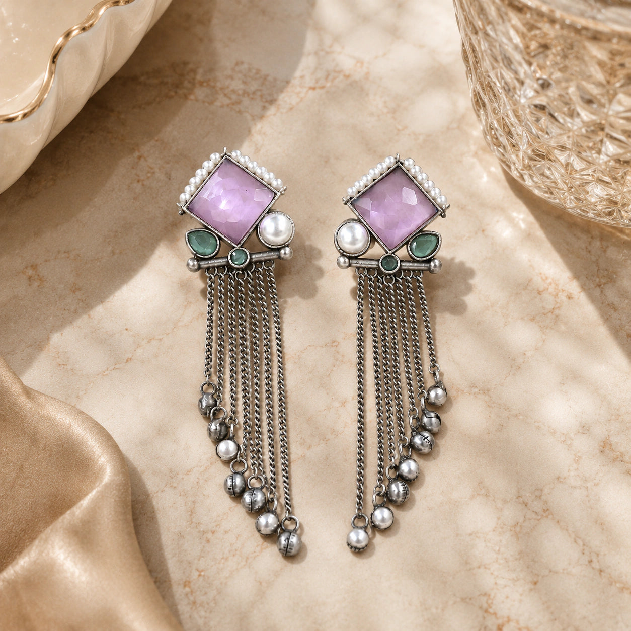 German silver pink pearl-style dangle earrings styled in a jewellery flat lay