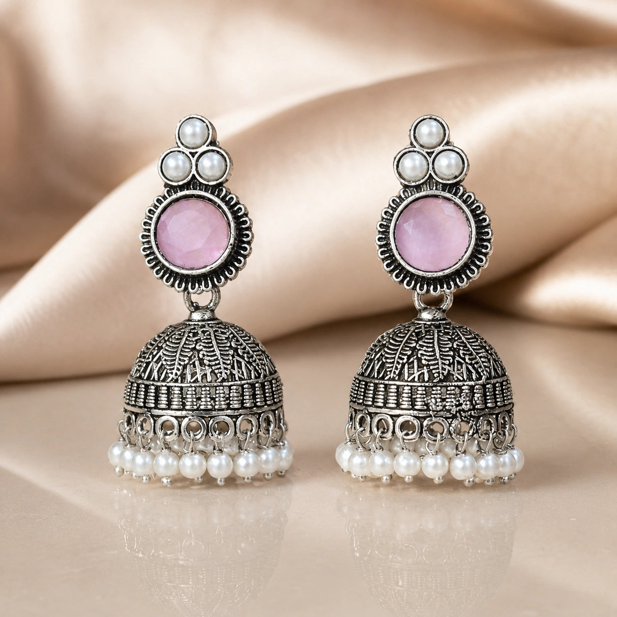 Close-up of pink accents, pearl-style beads and German silver jhumka detailing