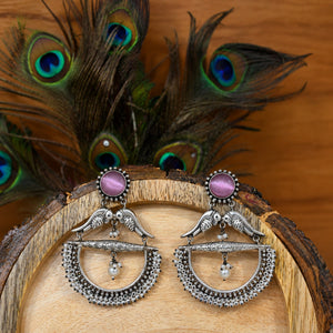Purple bird pearl chandelier earrings styled in an elegant jewellery flat lay