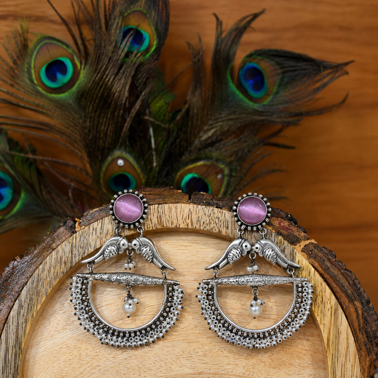 Purple bird pearl chandelier earrings styled in an elegant jewellery flat lay