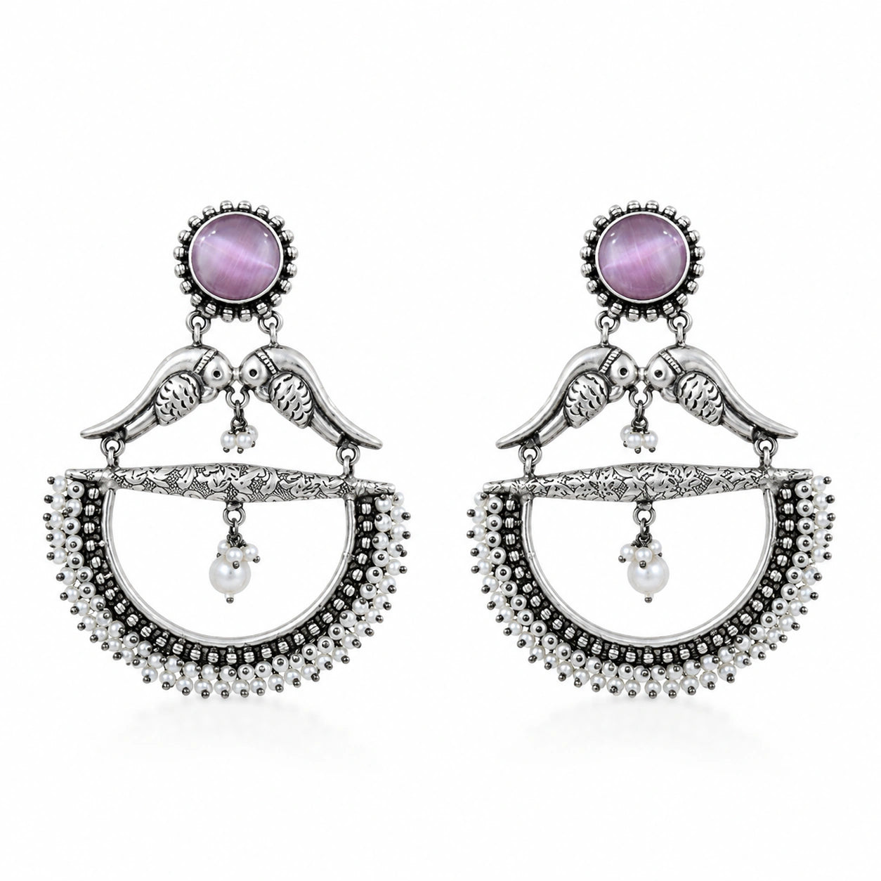 Close-up of purple accents, bird motifs and pearl chandelier detailing