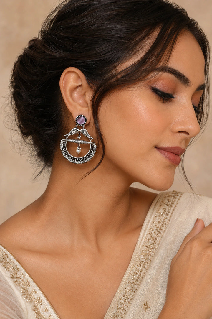 German silver purple bird pearl chandelier earrings worn by a model