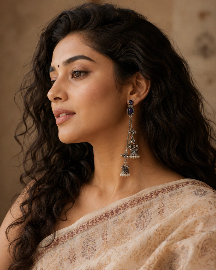 German silver purple crystal-style pearl chandelier earrings worn by a model