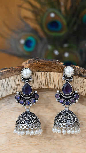 Close-up ear view showing purple leaf details and pearl dome jhumka drops