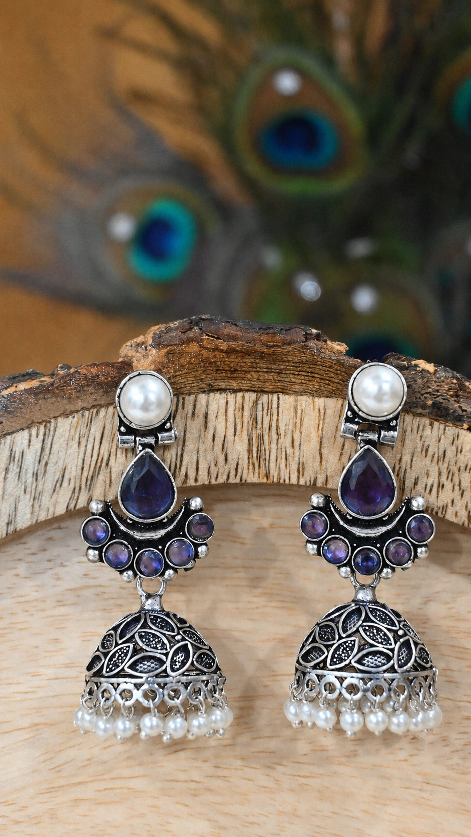 Close-up ear view showing purple leaf details and pearl dome jhumka drops