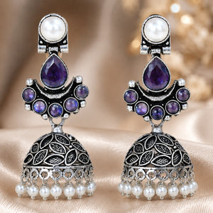Purple pearl leaf dome jhumka earrings styled in an elegant jewellery flat lay