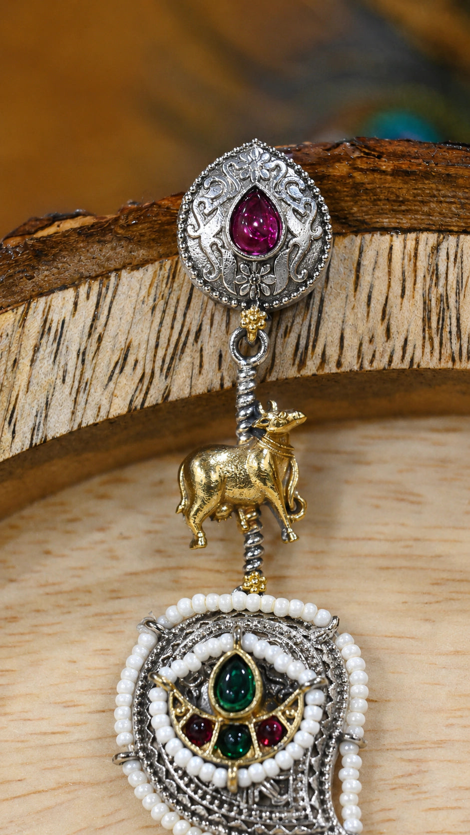 Close-up ear view showing rani pink accents, cow charms and pearl layers
