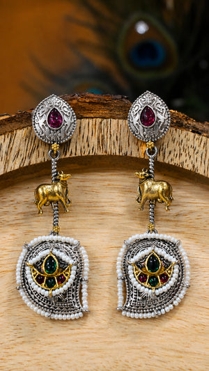 German silver rani pink cow charm chandelier earrings worn by a model