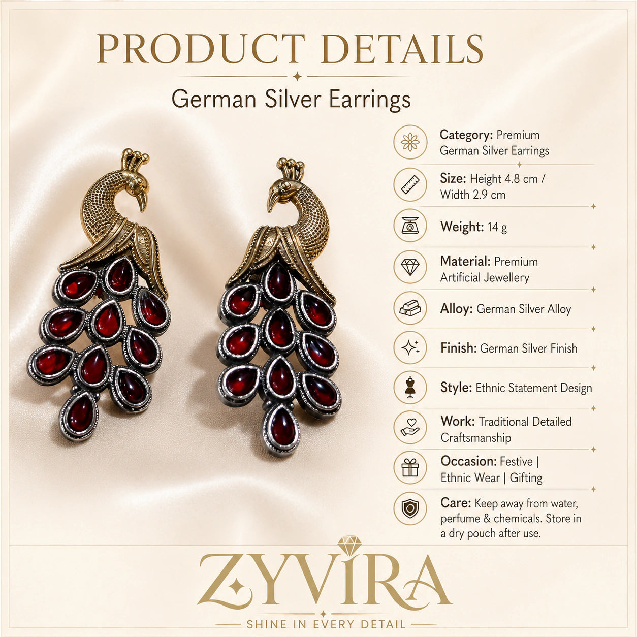 Red peacock chandelier earrings on a glossy dark reflective jewellery display