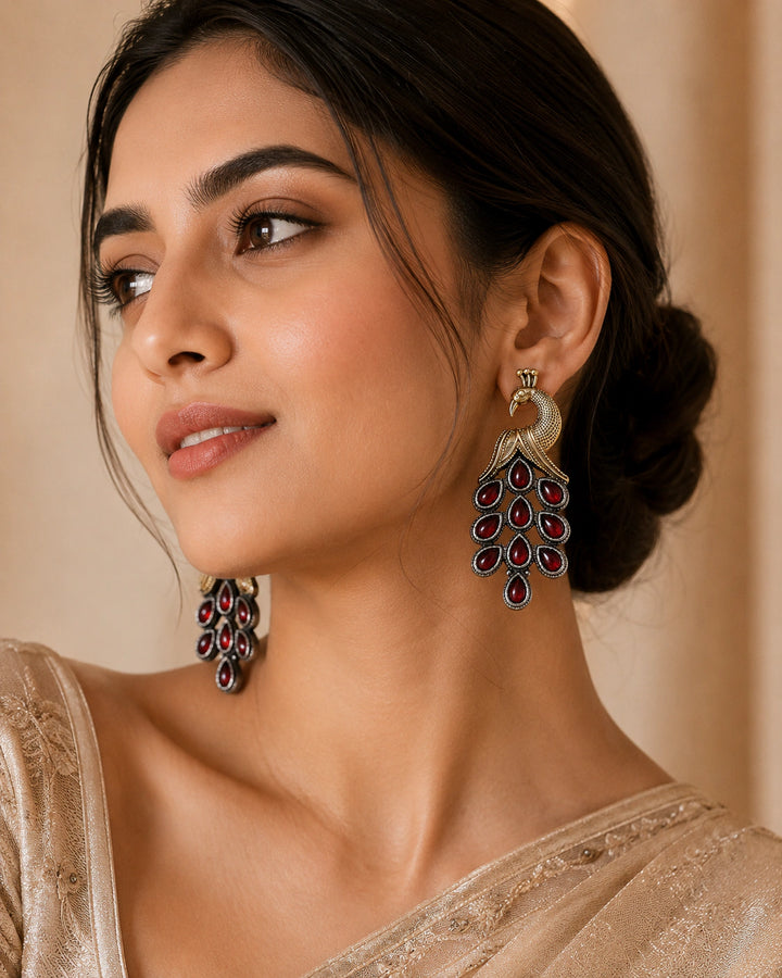 German silver red peacock chandelier earrings worn by a model