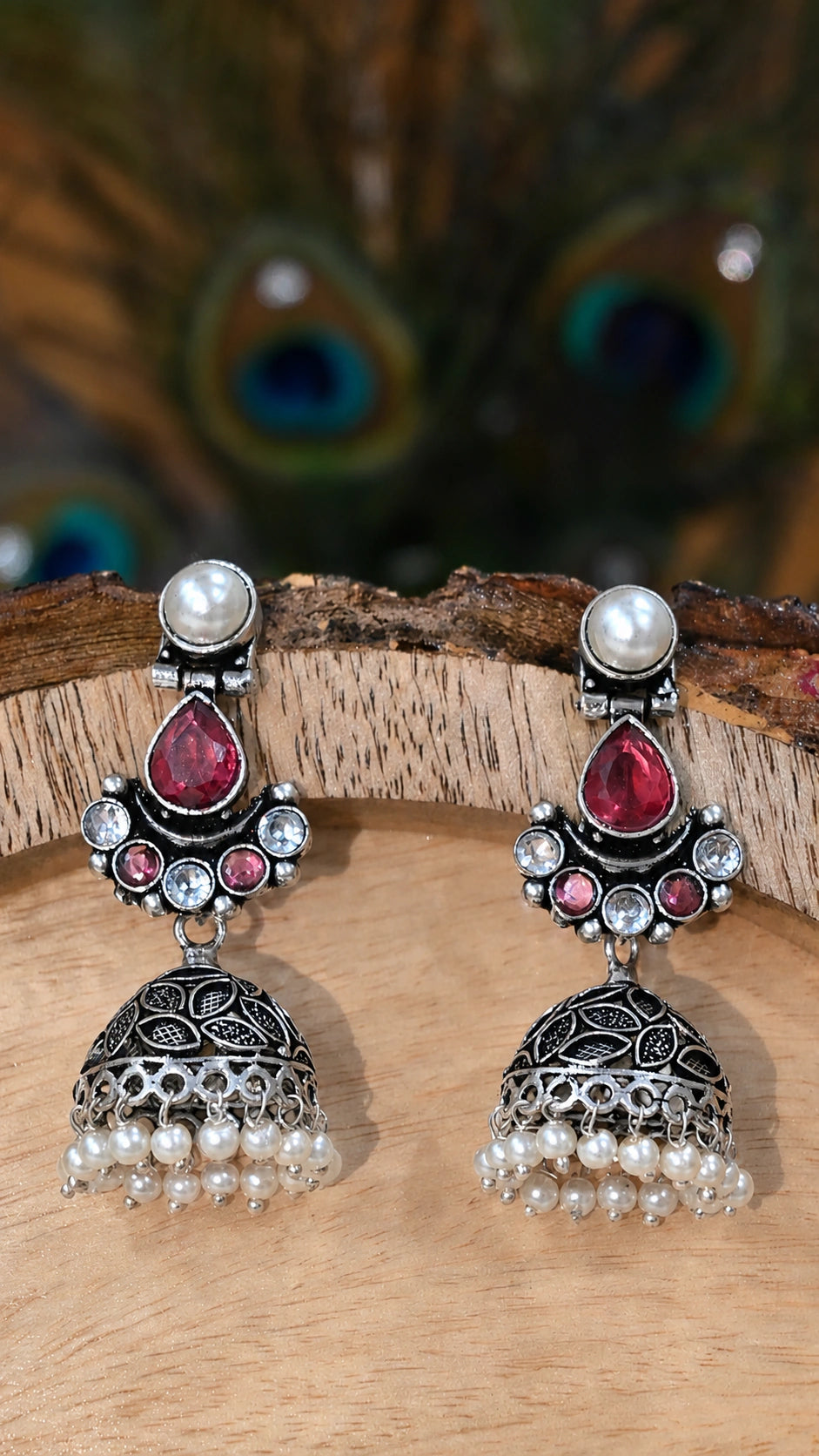 Close-up ear view showing ruby-tone leaf details and pearl jhumka drops