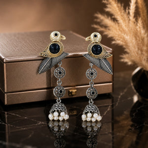Sparrow pearl dangle earrings on a dark jewellery studio display