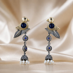 Angled view of German silver sparrow earrings with pearl-style jhumka drops