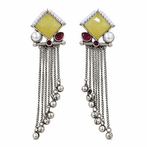 Angled view of German silver yellow and maroon pearl-style fringe earrings