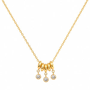 Angled view of the gold bead-cluster crystal charm necklace