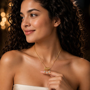 Gold bead-cluster crystal necklace on a dark jewellery studio display