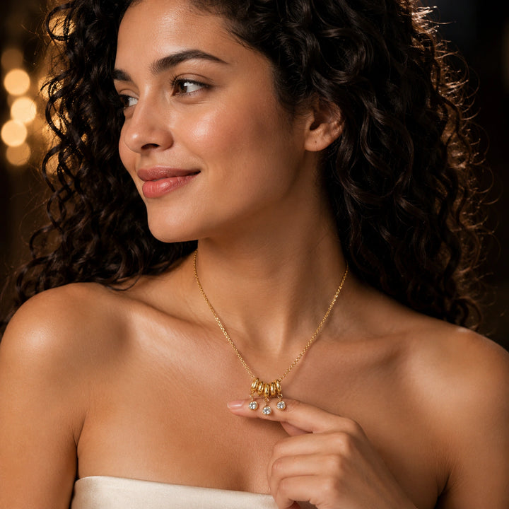 Gold bead-cluster crystal necklace on a dark jewellery studio display