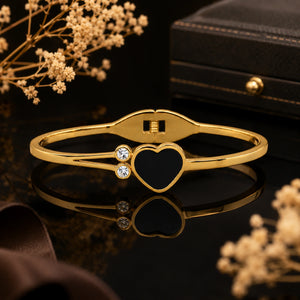 Angled view of the gold black-heart double-band kada