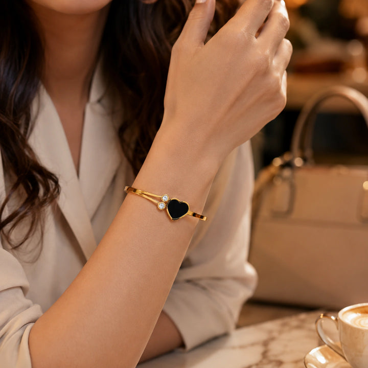 Gold black-heart crystal double-band kada on a dark jewellery studio display