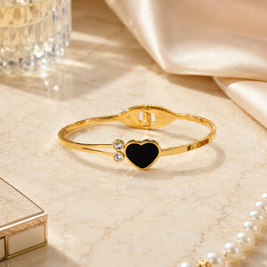Side view of the gold black-heart double-band kada