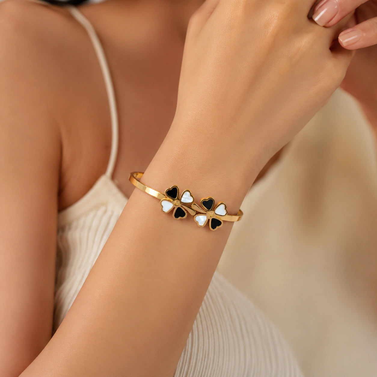 Angled view of the gold black clover crystal kada