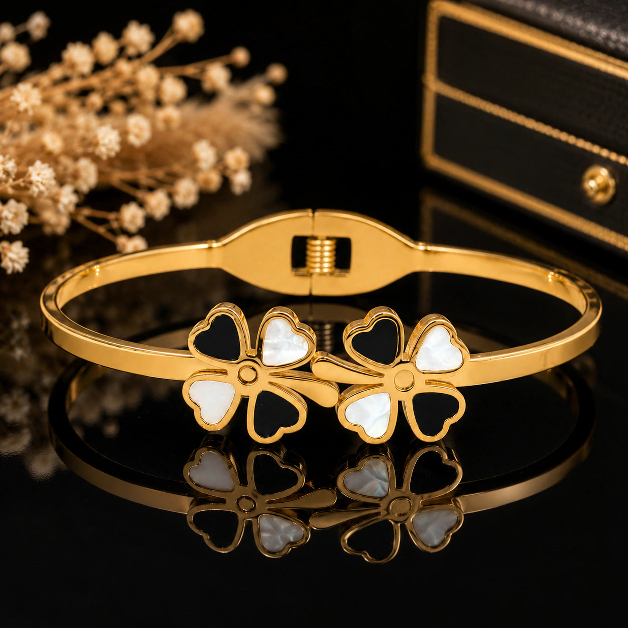 Close-up of black clovers, pearl-style accents and crystal detailing