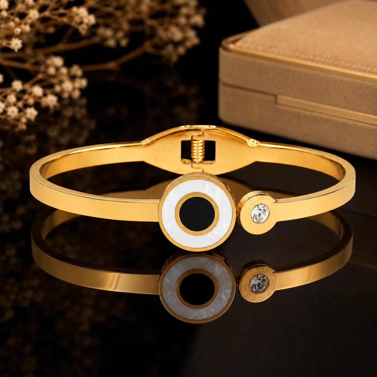 Angled view of the gold black-centre halo crystal kada