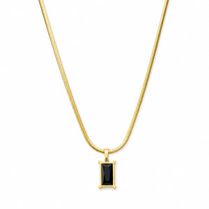 Angled view of the gold black stone snake-chain necklace