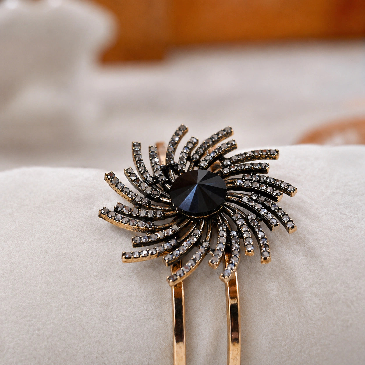 Gold black sunburst kada styled in an elegant jewellery flat lay