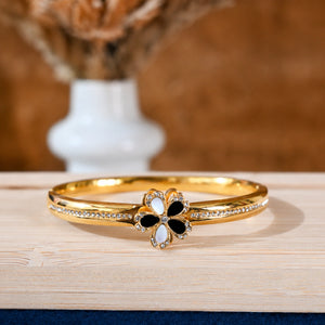 Gold floral crystal bracelet styled in an elegant jewellery flat lay