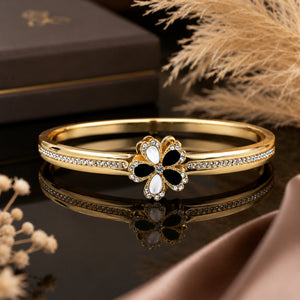 Gold-tone black and white floral crystal rigid bracelet