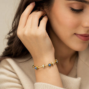 Angled view of the gold blue evil-eye crystal bracelet
