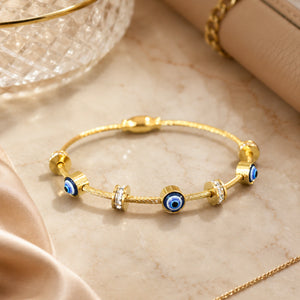 Close-up of the blue evil-eye charm and crystal detailing
