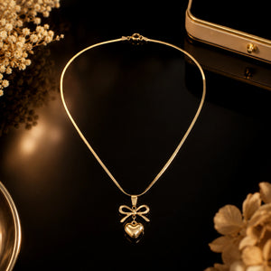 Alternate product view of the gold bow heart necklace