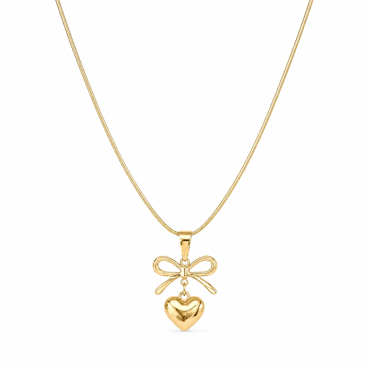 Close-up of the sculpted bow and heart pendant detailing