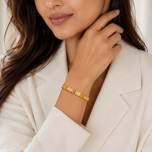 Angled view of the gold brushed link crystal kada