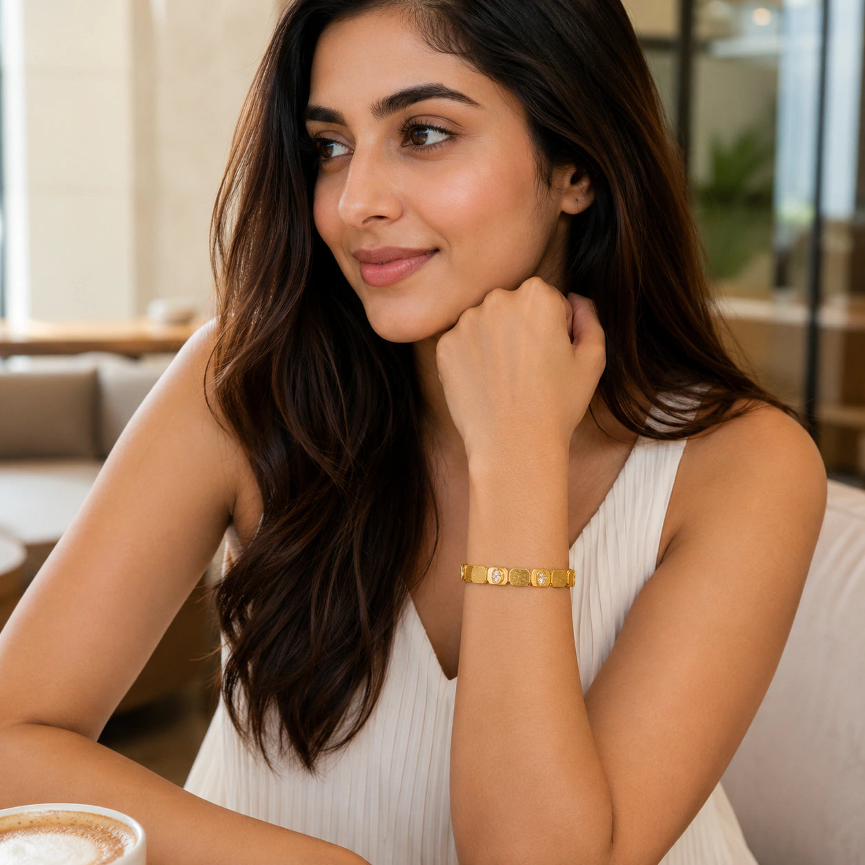 Gold brushed link crystal kada on a dark jewellery studio display