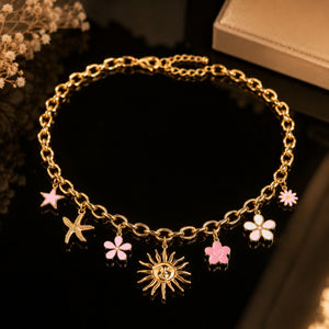 Angled view of the gold celestial floral charm necklace